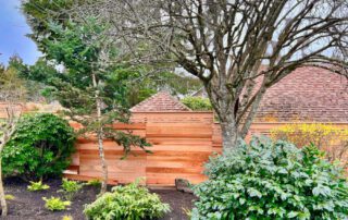 Horizontal style western red cedar privacy fence with decorative top