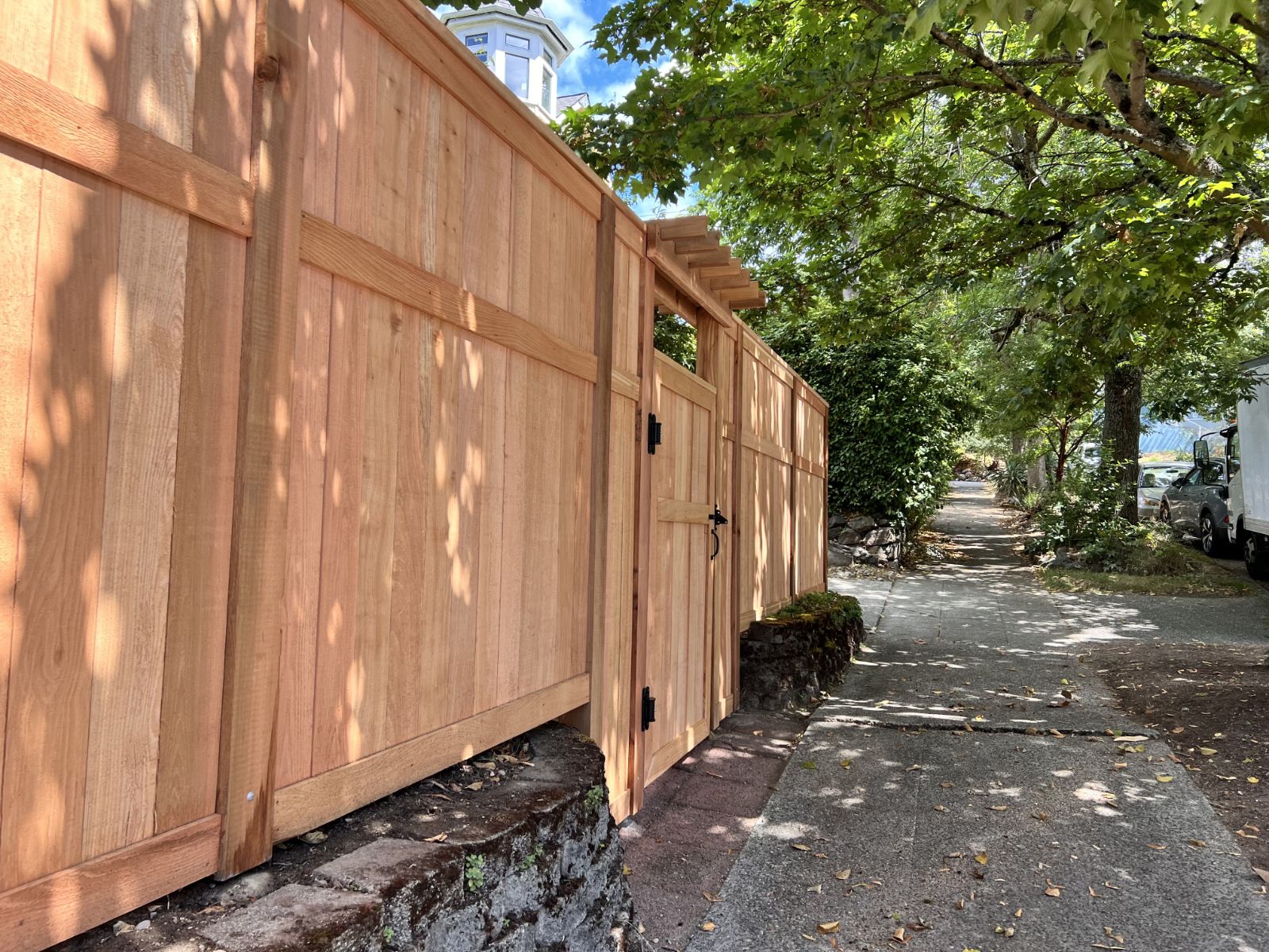 View of wood soundproof fence from the sidewalk